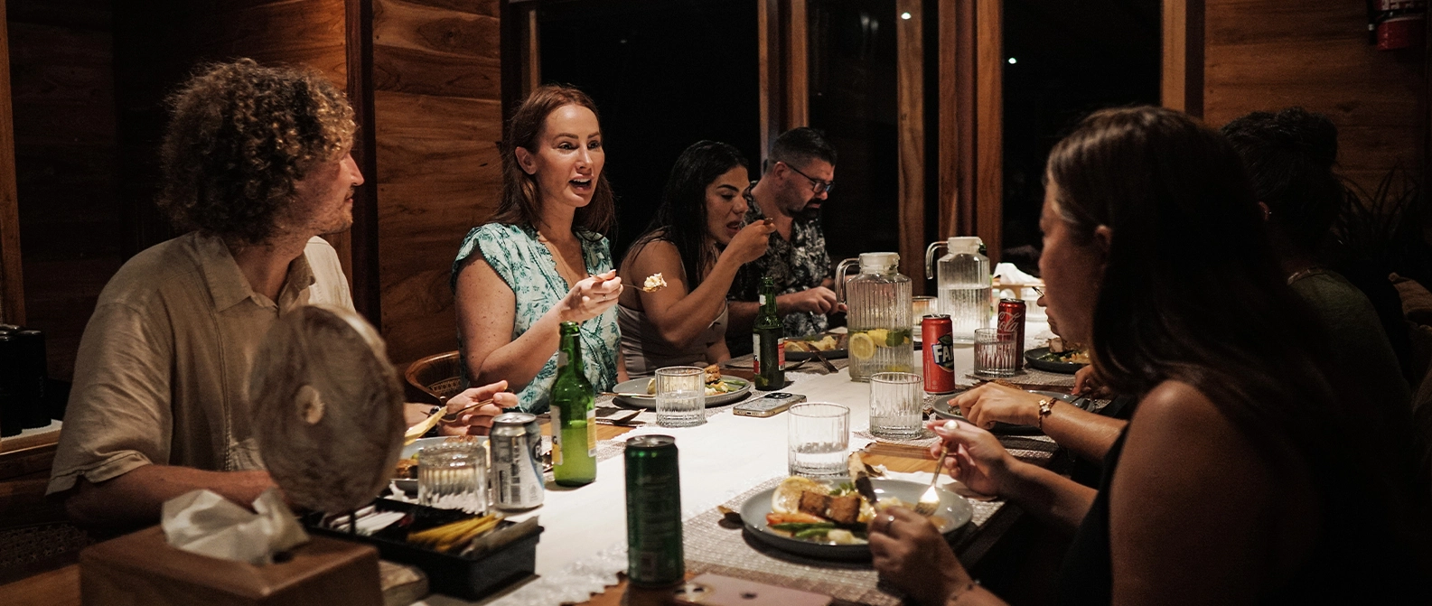 Passengers dining on a liveaboard boat during sunset in Komodo